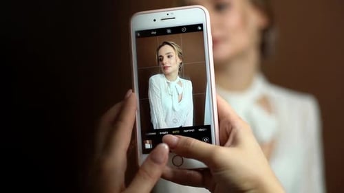 Woman Taking Photo of Fashionable Woman with Phone