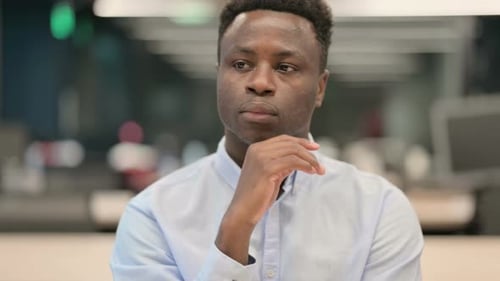 Thoughtful Man Contemplates Solutions in Office Environment