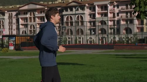Man Jogging in an Urban Park Setting
