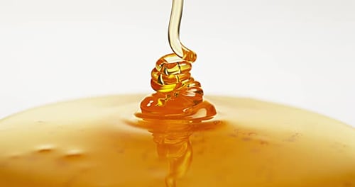 Honey Flowing against White Background, Slow Motion 4K