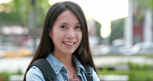 Woman Smiling at Camera in Urban Setting