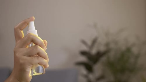 Hand Sprays Liquid From Clear Spray Bottle