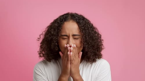 Sick African American Female Sneezing Over Pink Studio Background