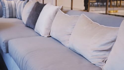 dolly shot of close up sofa beige color fabric pillow cushions luxury home