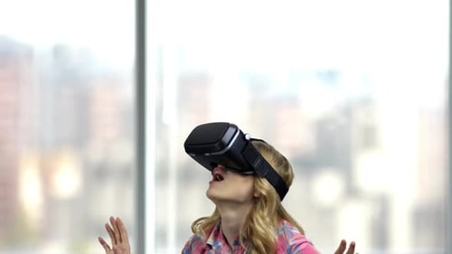 Woman Enjoys Virtual Reality Experience With VR Headset