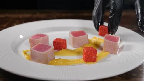 Chef Garnishing Tuna Cubes on Plate