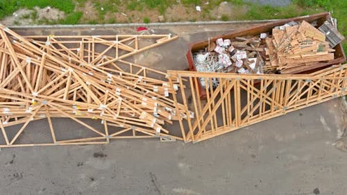 Construction Trash Dumpsters in an Metal Container Stacker Wooden Material Boards and Beams Home