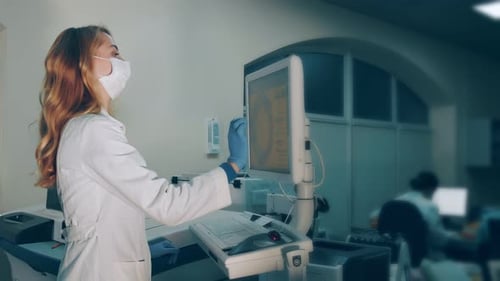 Female Healthcare Worker Analyzes Chest X-Ray