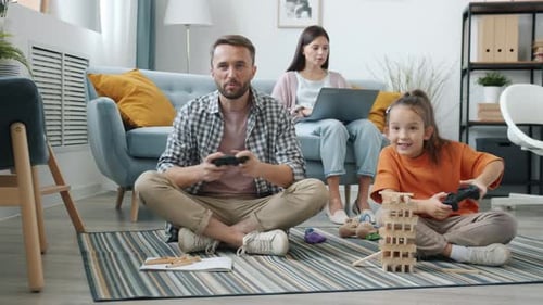 Family Enjoys Video Games Together at Home