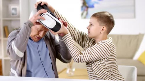 Grandson Helps Grandfather With Virtual Reality Headset