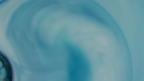 Blue Ink Swirling in Liquid Macro Shot