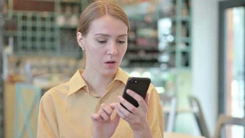 Woman Reacts With Shock to Phone News