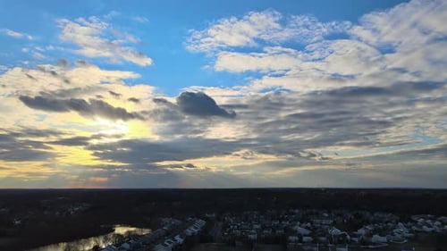 Aerial View of Town Along the River with Residential Areas of Private Houses on Colorful Clouds in