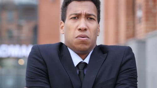 Young Adult in Suit Expressing Frustration