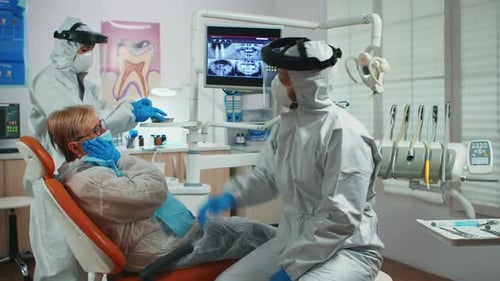 Dentist Treating Patient in Dental Office