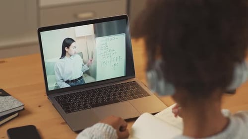 Child Attends an Online Math Class at Home