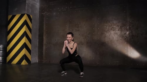 Athletic Beautiful Woman Doing Exercises in the Gym