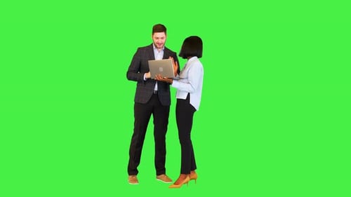 Cheerful Colleagues Using Laptop on a Green Screen