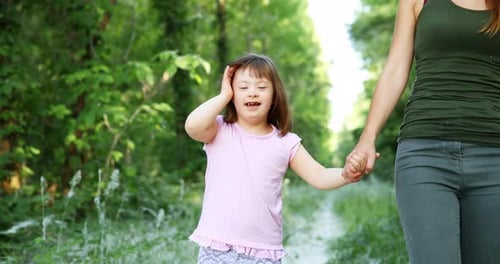 Child and Adult Walk Together in Nature