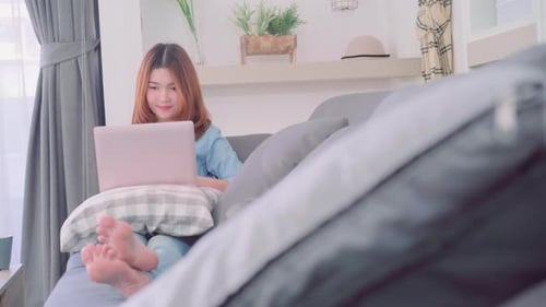 Woman Works on Laptop in Relaxed Living Room
