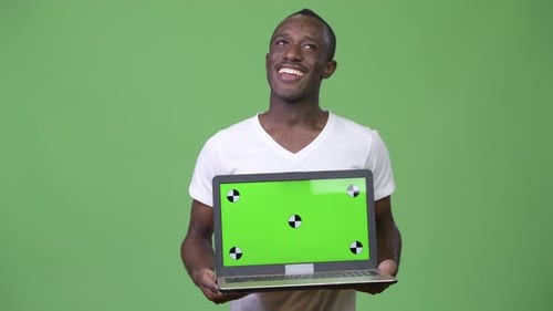 Man Holding Laptop with Chroma Key Screen