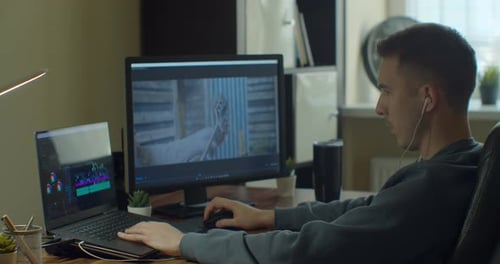 Young Adult Man Video Editing at Desk