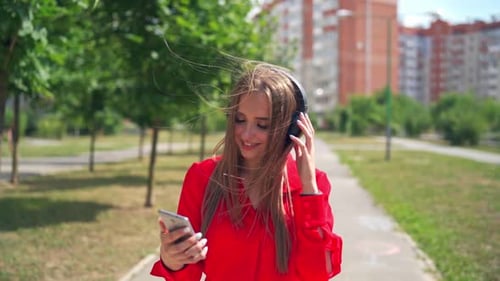 Girl listening to music in headphone. Attractive young woman listening to music in headphone