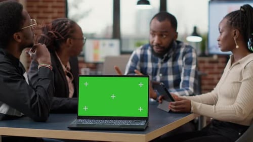 Team Meeting Around Laptop With Green Screen