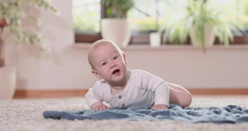 Close Up of Little Baby Crawling on the Rug and Blanket on the Floor Rising at All Four and Delicate