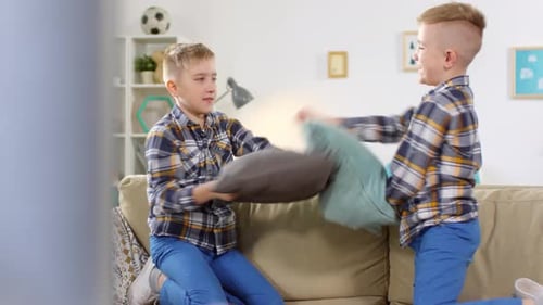 10-Year-Old Twins Having Vigorous Pillow Fight
