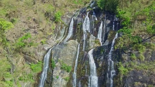Flycam Close View Waterfall Cascade From Cliffs in Tropics