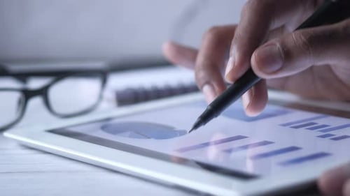 Stylus Used on Tablet Showing Charts