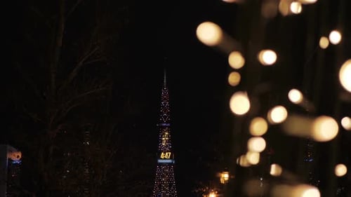 Illuminated Tower Displaying Time at Night