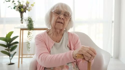 Elegant Senior Woman Talking in Bright Home