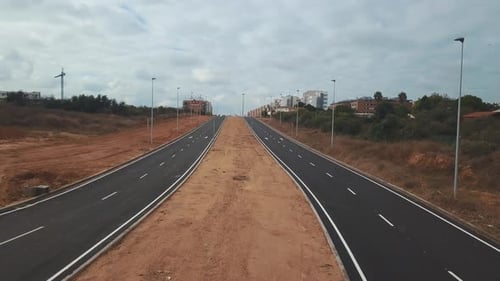 Aerial view of the construction of a new highway. Ascending.