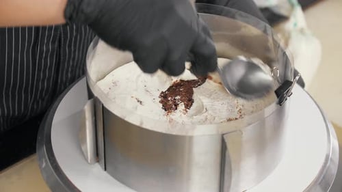 Confectioner Smears Vanilla Cream Onto Sponge Cake
