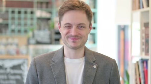 Smiling Man in Blazer Looks at Camera