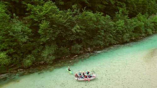 Aerial view of rafters doing rafting in turquoise water going down at Soca river