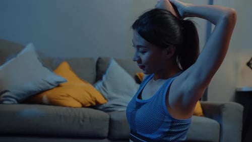 Athletic Woman Stretches in Her Living Room