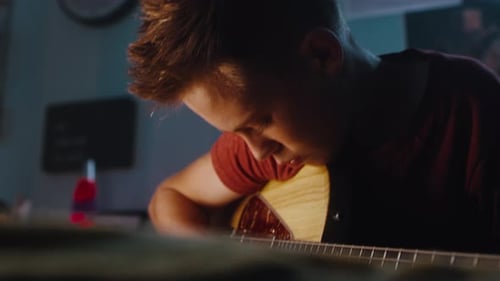 Teen Plays Electric Bass Guitar in Bedroom