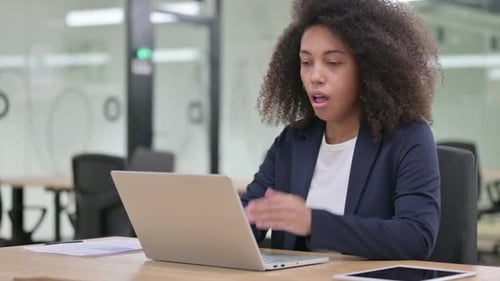 Businesswoman Coughing While Working at Laptop