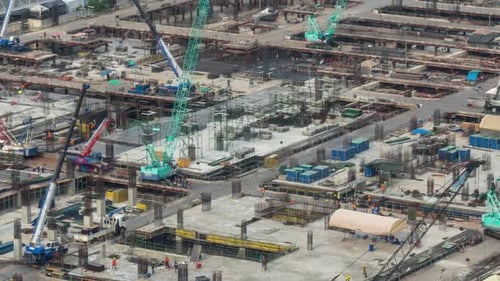 Time lapse of construction site with heavy construction machinery in metropolis