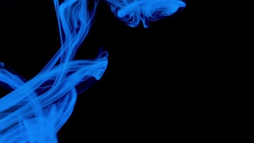 Abstract Blue Ink Swirling in Water on Black