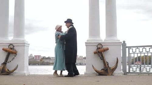 Senior man and woman dancing together in the park. The concept of a healthy lifestyle.