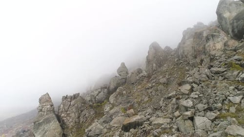 Foggy Mountainside Landscape with Rocky Terrain