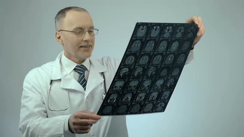 Doctor Examining Brain Scan in Hospital Setting