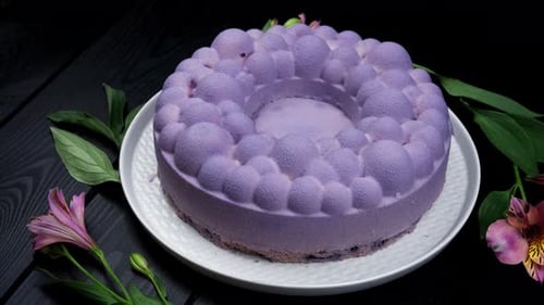 Delicious Decorative Cake Surrounded by Greenery and Flowers