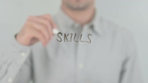Man Writes Skills on Transparent Surface