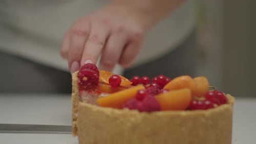 Cutting Piece of Cheesecake with Raspberries Apricot Fruits and Currant in Slow Motion