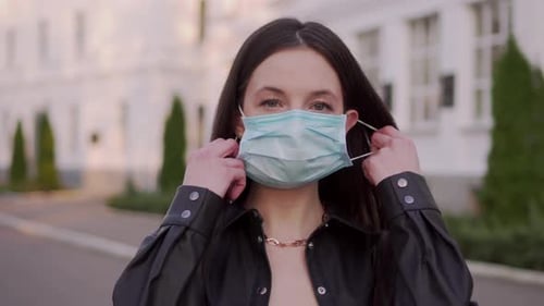 Female Teenager Takes Off Protective Mask.